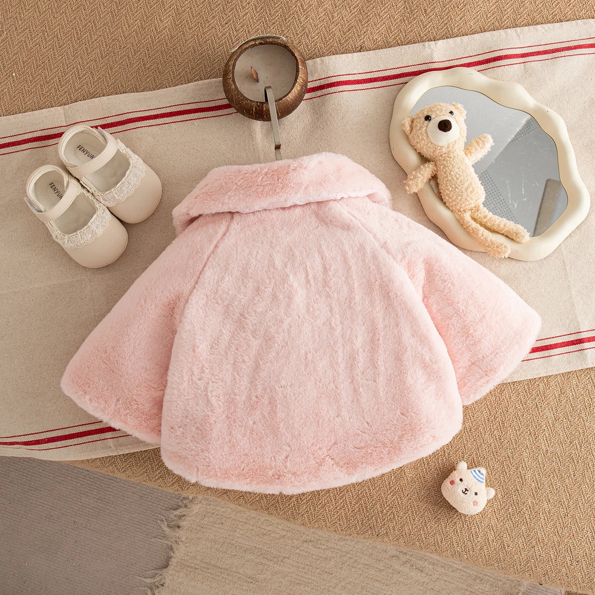 Back view of the blush pink baby faux fur cape coat