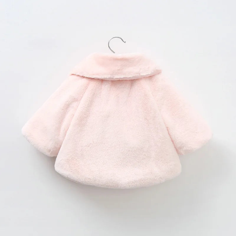 Back view of the blush pink baby faux fur swing coat