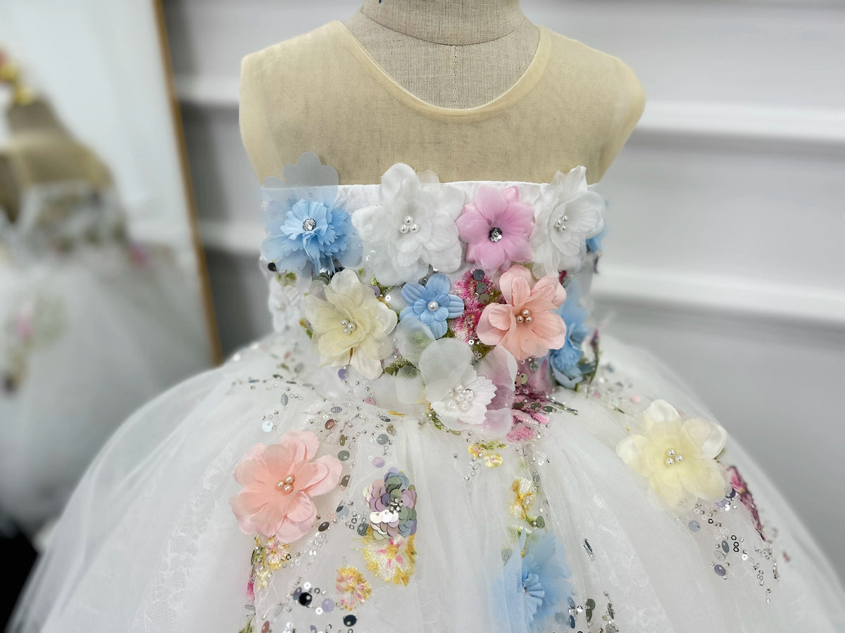 Detail of the pink, blue and white 3D floral appliqués and sequins on the tulle skirt