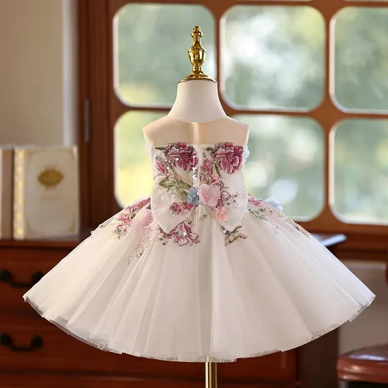 Back of the flower girl tulle dress with a big embroidered floral bow