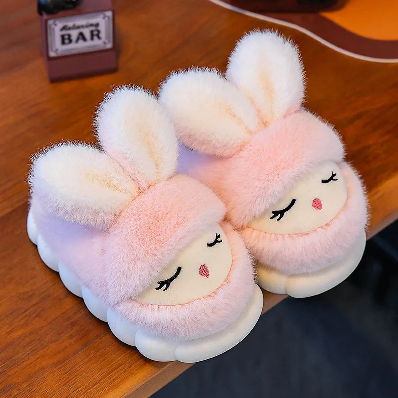 Blush pink bunny slippers with sleepy face and fluffy white ears