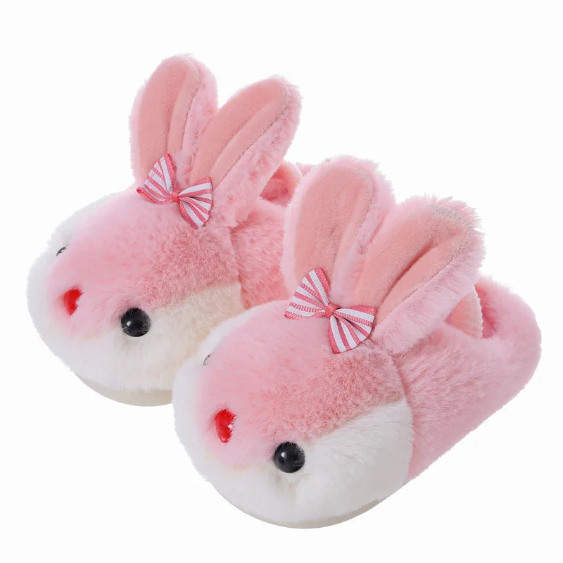 Pink girls fluffy bunny slippers on white background