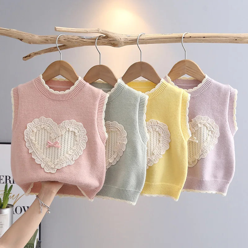 Girls heart knit sweater vest with ruffle trim in blush pink, sage green, butter yellow and lavender