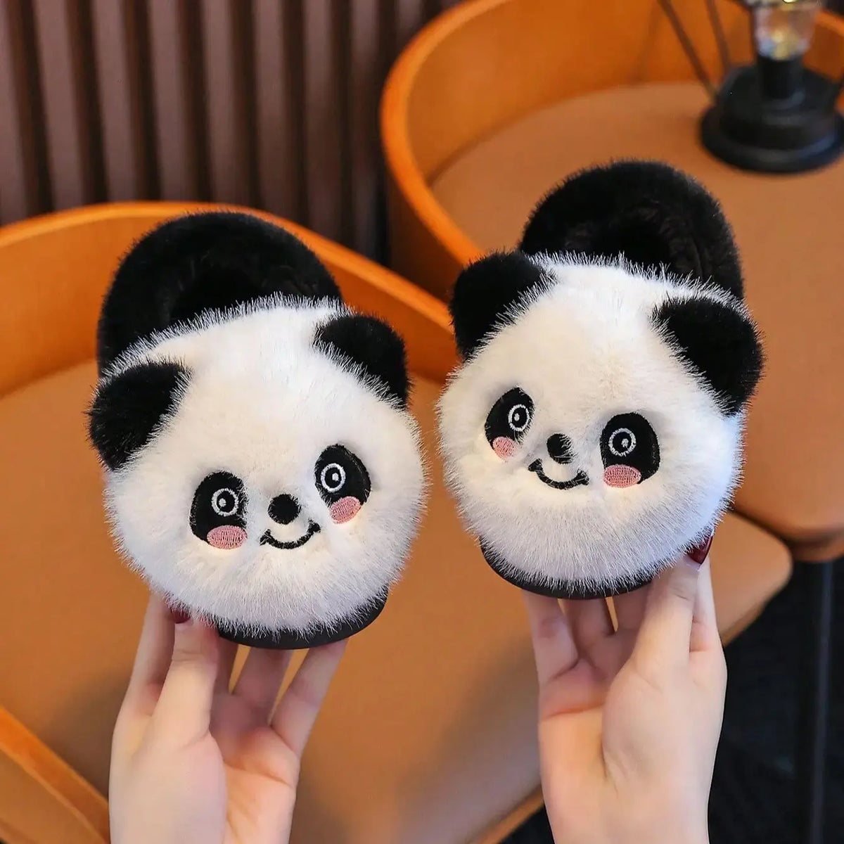 Close-up of panda slipper face with pink cheeks and black ears