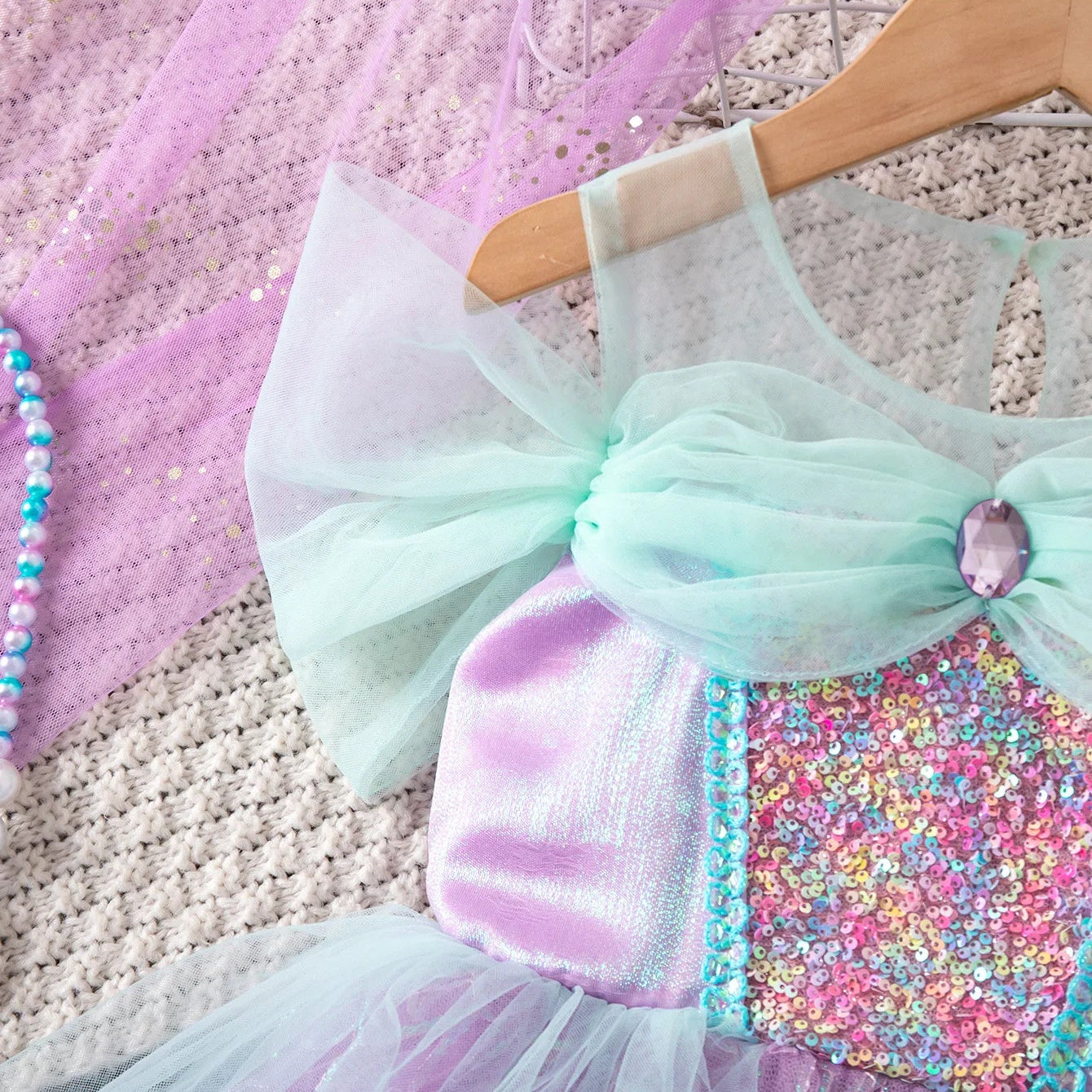 Close-up of glittering sequin bodice on girls' mermaid costume dress