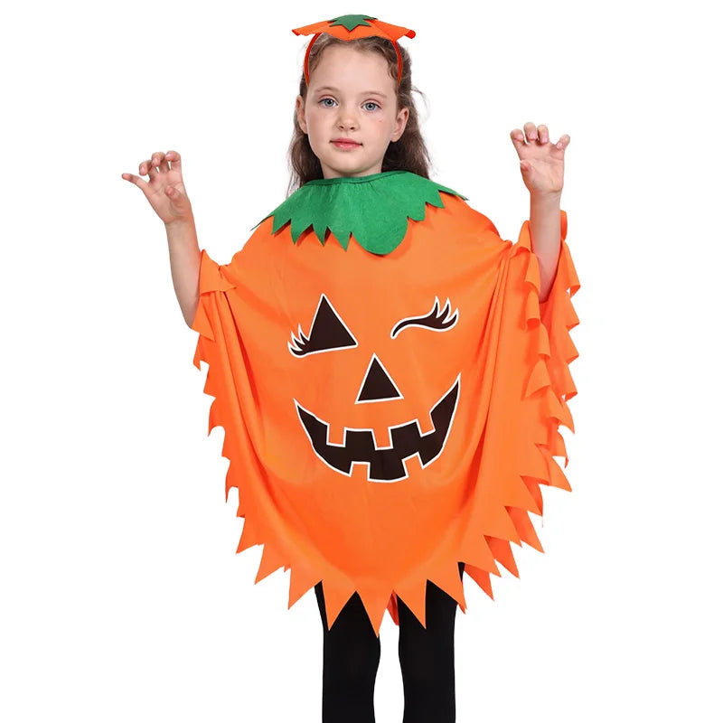 Child wearing a flowing pumpkin witch Halloween cloak