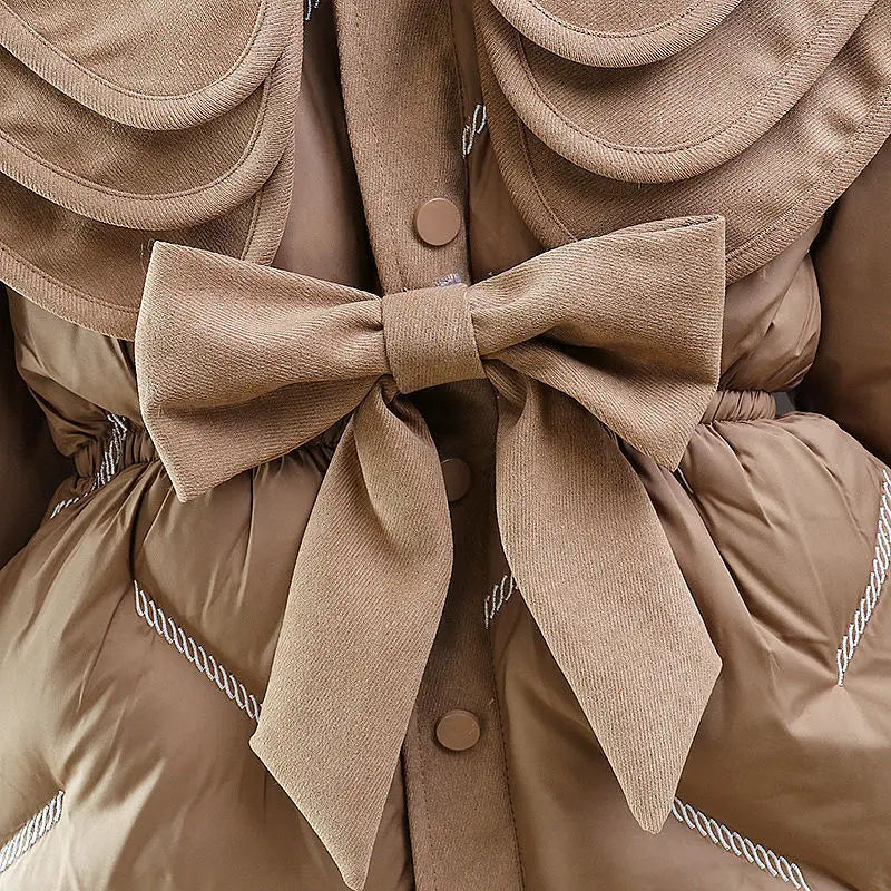 Side view of the tiered ruffle collar on the toddler girl winter coat