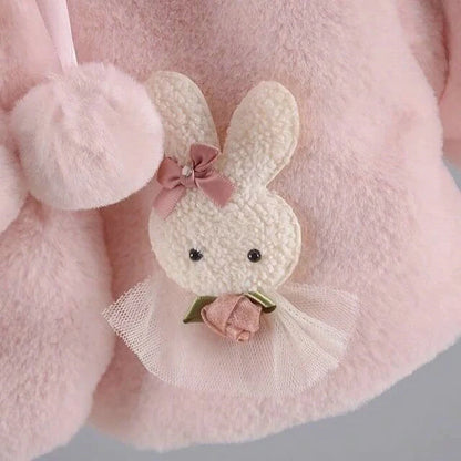 Close-up of the bunny appliqué with tulle skirt and rose on the baby faux fur coat