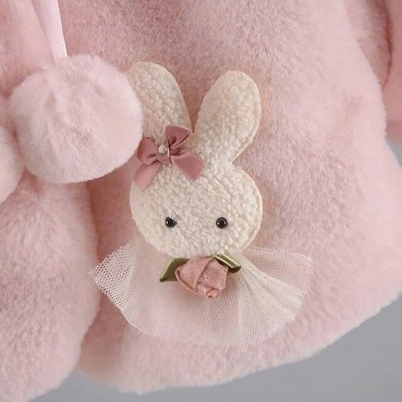 Close-up of the bunny appliqué with tulle skirt and rose on the baby faux fur coat