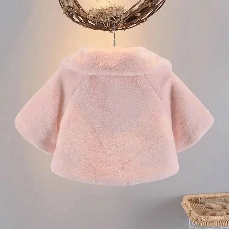 Back view of the blush pink baby faux fur swing coat