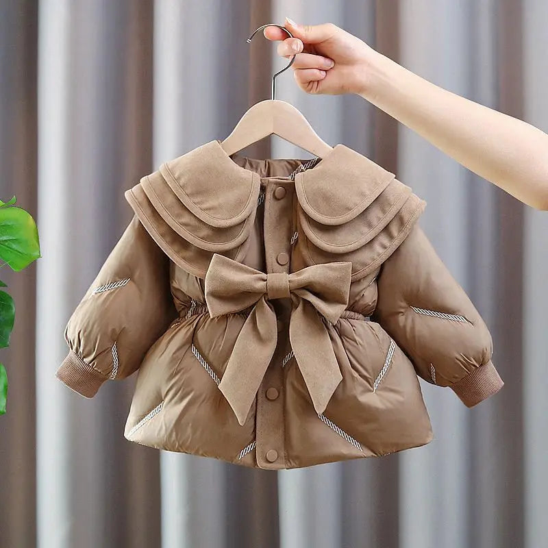 Baby and toddler girl winter coat in camel with big bow, shown on a hanger