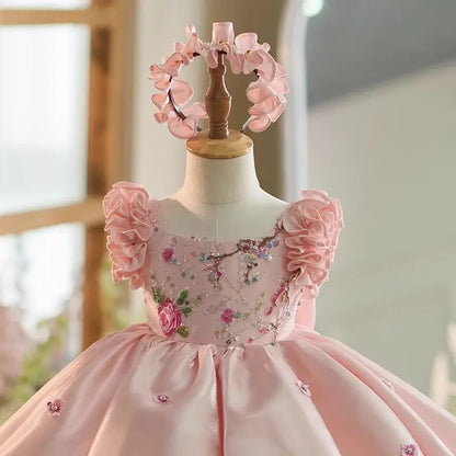 Close-up of the embroidered floral bodice and square neckline on the pink satin flower girl dress