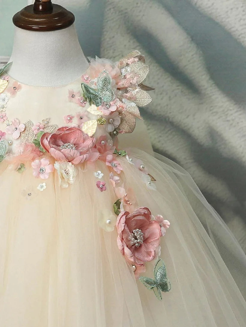 Close-up of the 3D floral shoulder details on the girls tulle princess gown