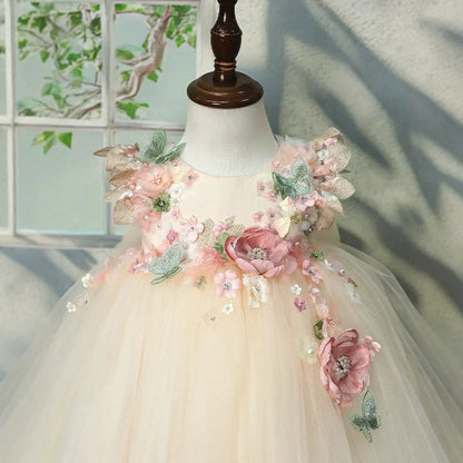 Close-up of the 3D flower bodice on the champagne flower girl gown