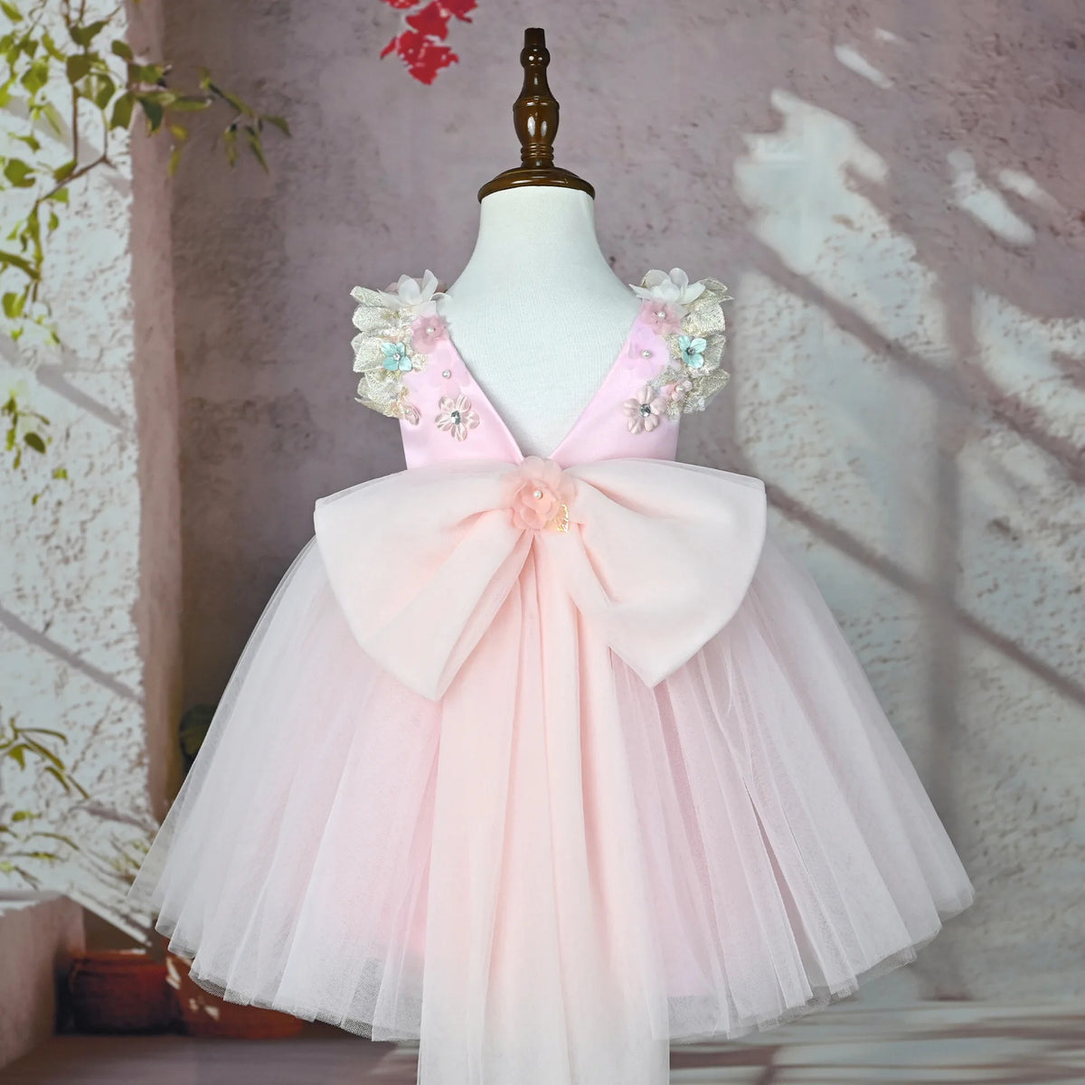 Back of the pink flower girl tulle gown with oversized bow