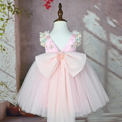 Back of the pink flower girl tulle gown with oversized bow