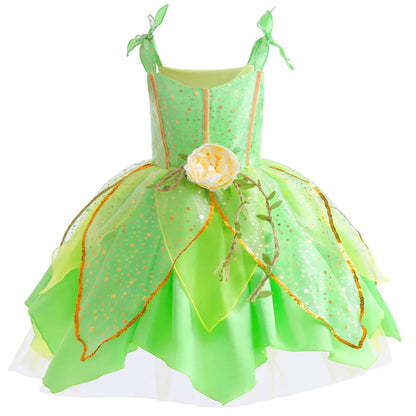 Little girl twirling in a green woodland fairy costume dress