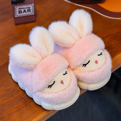 Blush pink bunny slippers with sleepy face and fluffy white ears