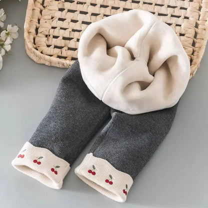 Charcoal gray girls leggings showing warm fleece lining and cherry cuffs