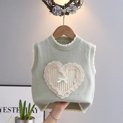 Sage green girls sleeveless knit vest with lace heart appliqué and bow