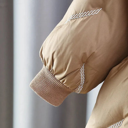 Sleeve detail of the toddler girl puffer coat with ribbed knit cuff and contrast stitching