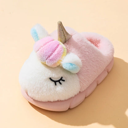 Close-up of pink unicorn plush slipper with rainbow pom-pom mane