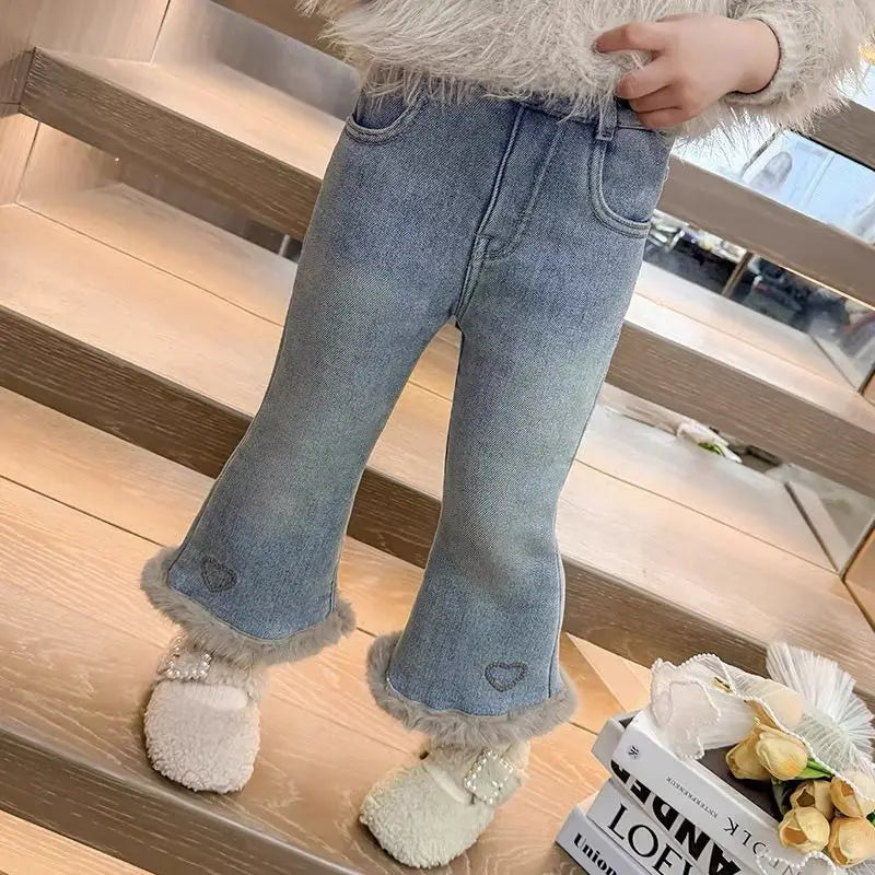 Front view of girls light wash winter flare jeans with heart embroidery