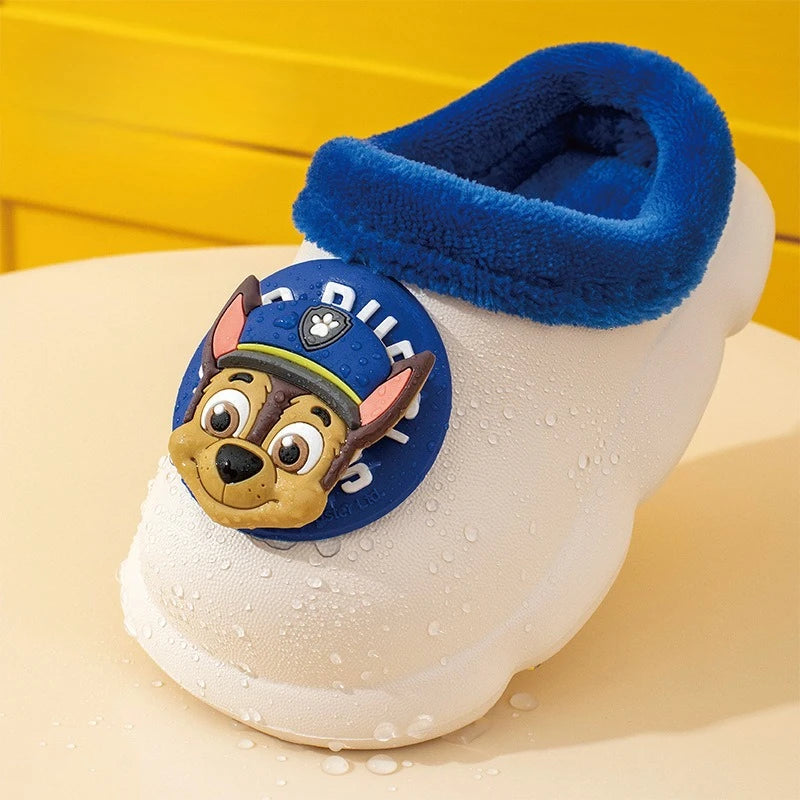 Close-up of white kids clog slipper with navy plush collar and puppy badge