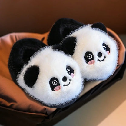 Pair of fluffy black and white panda slippers for kids