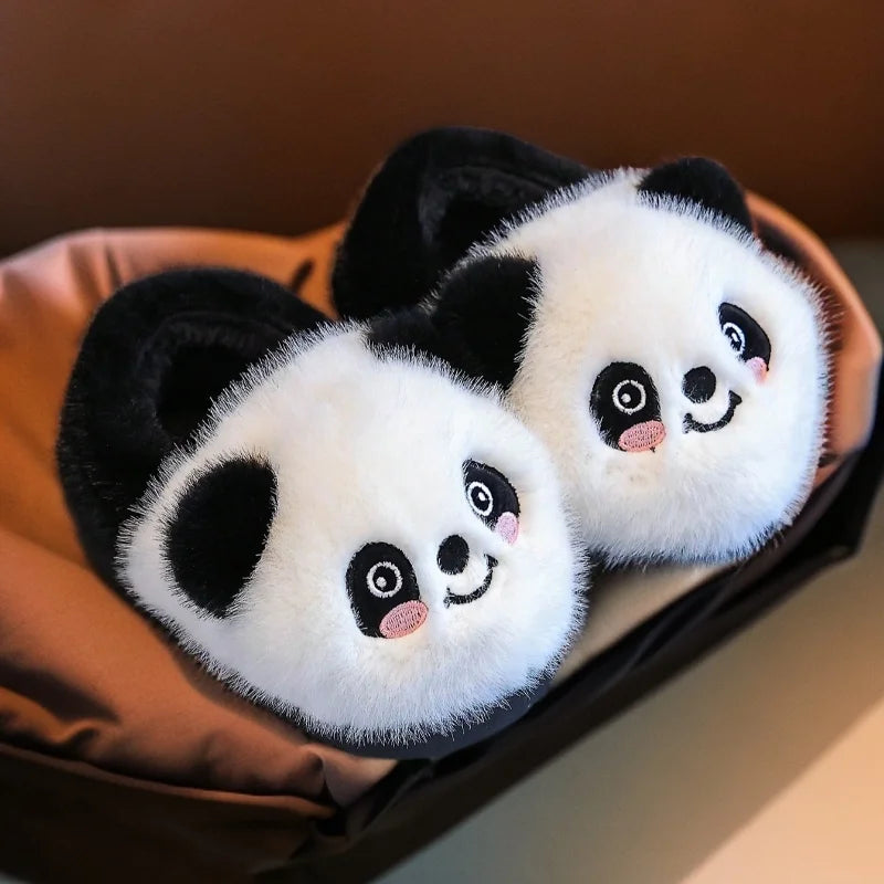 Pair of fluffy black and white panda slippers for kids
