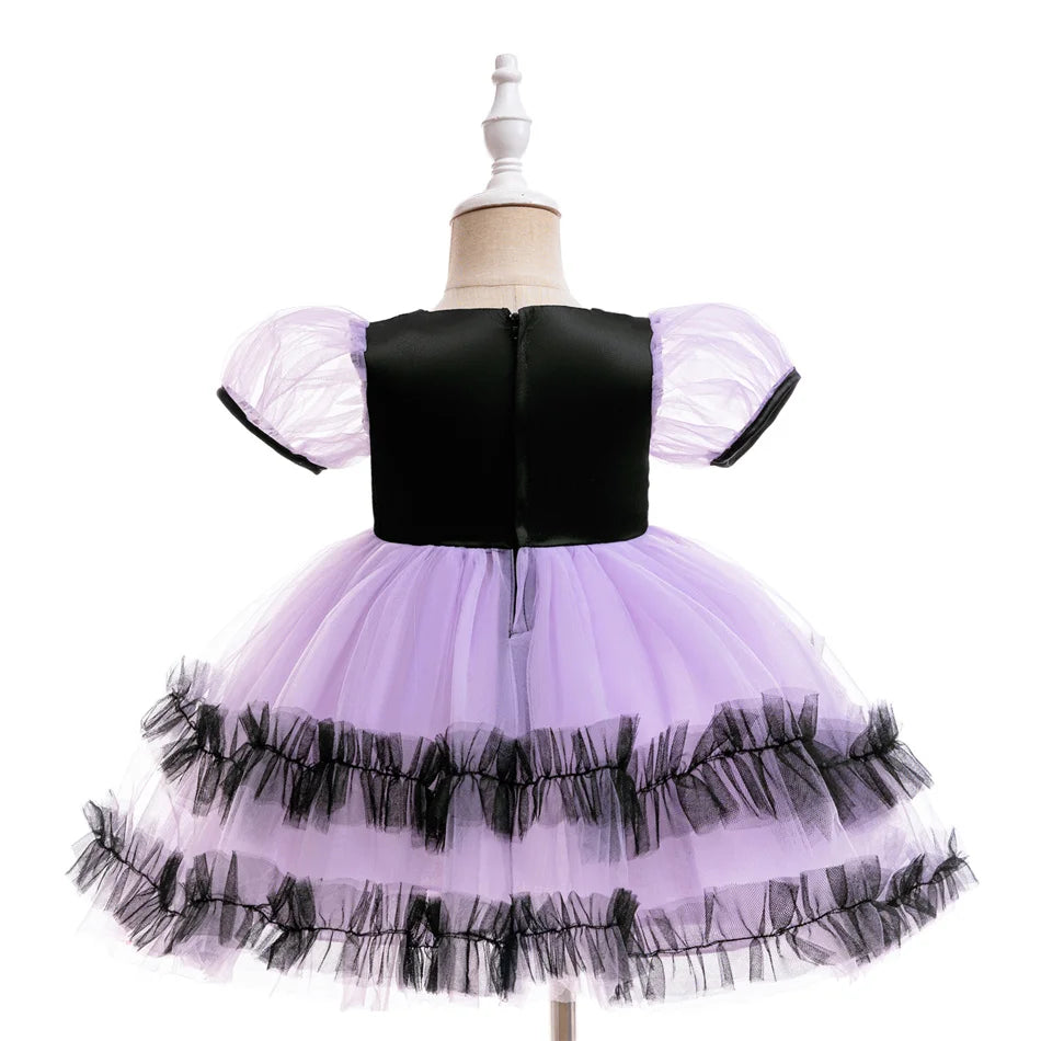 Purple toddler witch costume dress with puffed sleeves and spooky-cute print