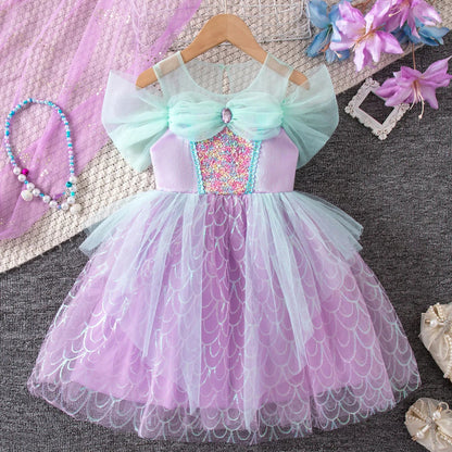Girl wearing sparkly mermaid costume dress with sequin bodice and flowing mesh skirt from Magic Tree Kids