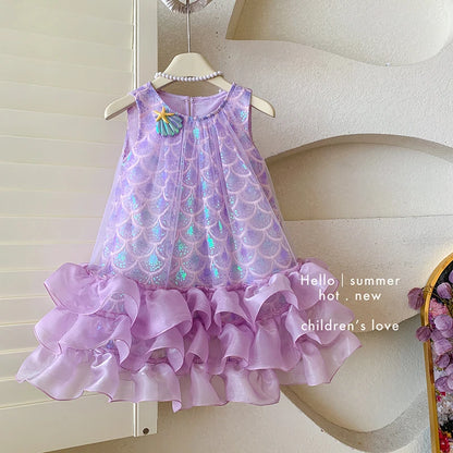 Little girl twirling in a flowing purple mermaid princess dress