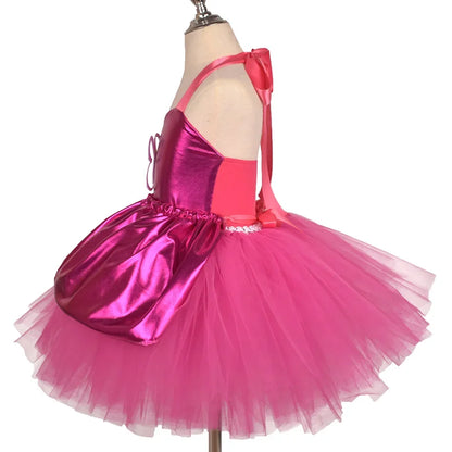 Girl twirling in rosy pink tutu party dress