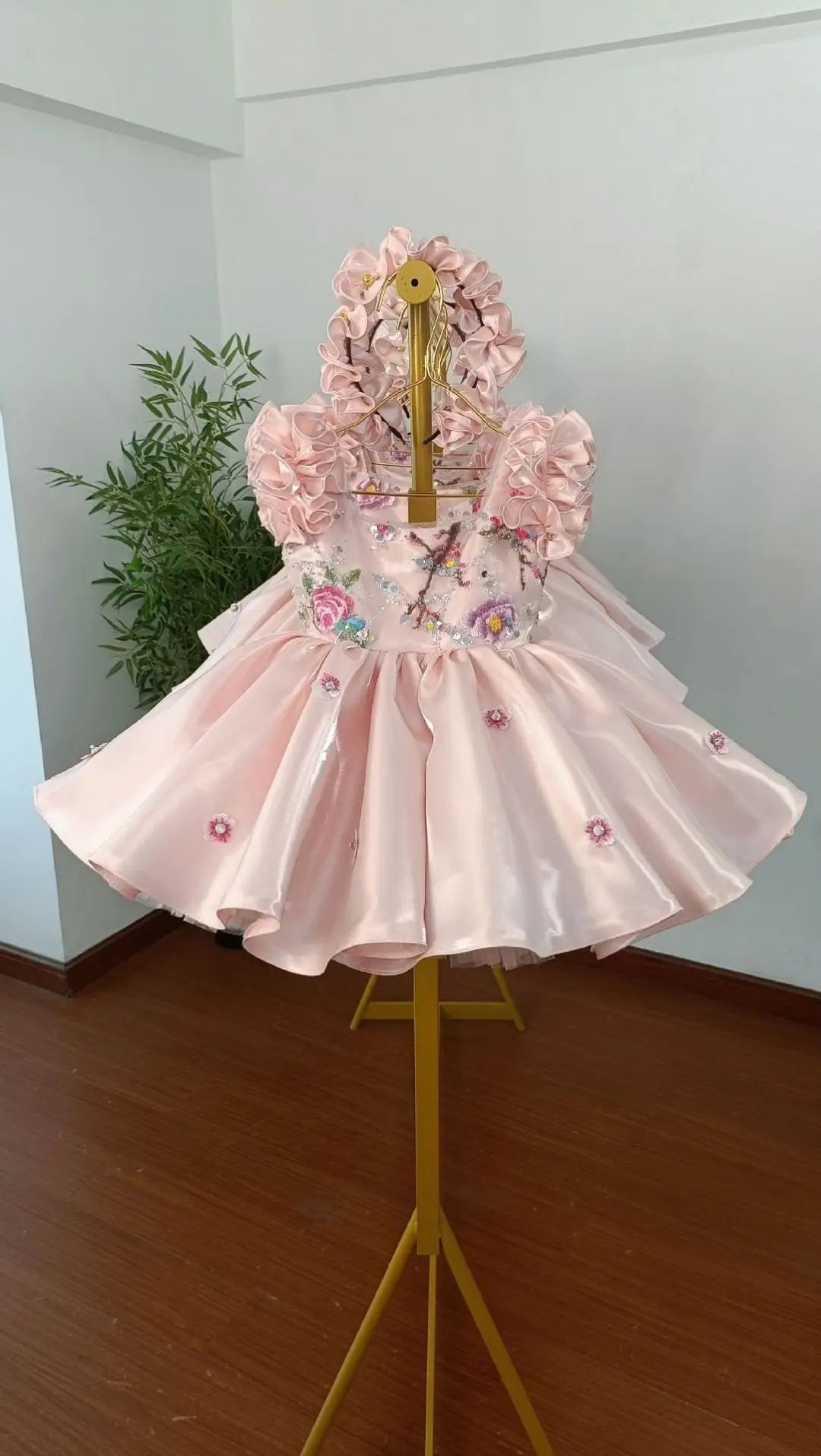 Side-back view of the pink satin flower girl dress with oversized satin bow