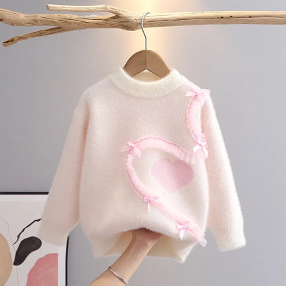 White knit pullover with round neckline and ruffle detail