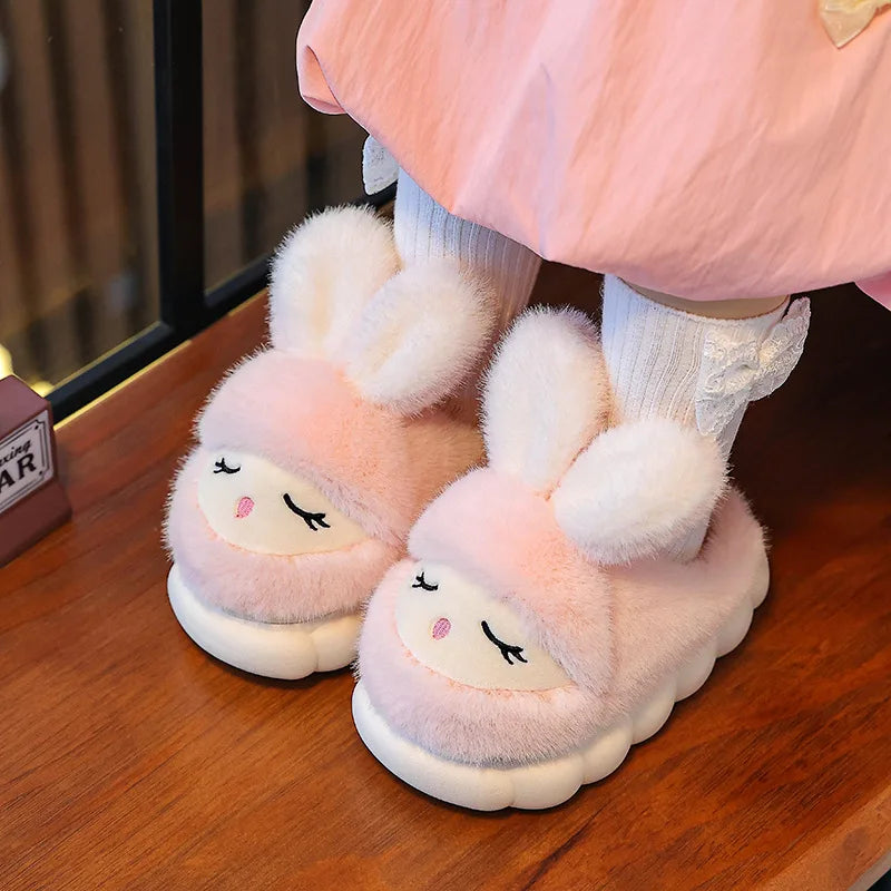 Toddler girl wearing pink fluffy bunny slippers at home